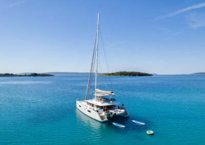 Aerial view of the Lagoon 560 catamaran, anchored in the crystal-clear waters of Croatia