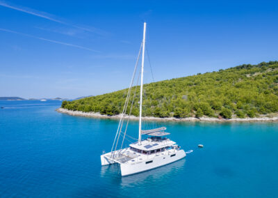 Aerial view of the Lagoon 560 catamaran, anchored in the crystal-clear waters of Croatia