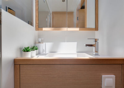 A modern bathroom on the Lagoon 560 catamaran. A spacious sink, a mirror, and ample storage space.