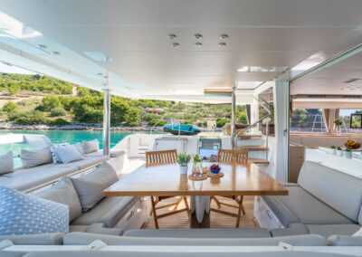 Spacious dining area on the back deck of the Lagoon 560 s2 catamaran, with a seabob in the background.